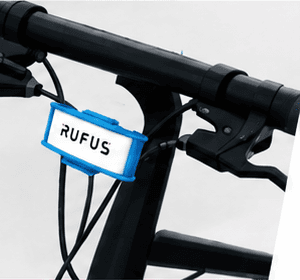 Tag RUFUS M8 Clip azul colocado en los cables de freno de una bicicleta